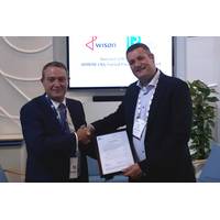 David Barrow, LR Commercial Director – Marine & Offshore presents the AiP to Maarten Spilker, Wison Solutions Director at Gastech this week in Barcelona. (Photo: Lloyd’s Register)