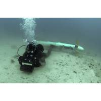 A diver tests underwater imaging system in the Arabian Sea, after an airborne platform "saw" this mine through the water. "The emphasis here," says Dr. Jason Jolliff, an NRL oceanographer who forecasts ocean optics, "is on developing models of the ocean environment to help the naval warfighter." (Photo: U.S. Navy)