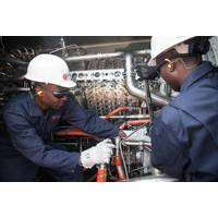 APR Energy operators doing routine maintenance on one of APR's mobile gas turbine generators at Rocha Pinto, Angola. Photo APR Energy