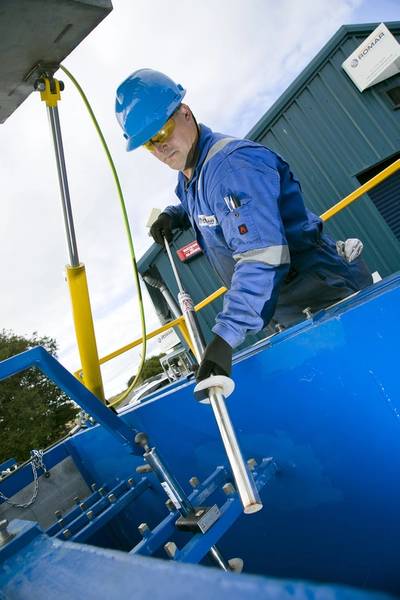 ROMAR employee working on a swarf handling unit