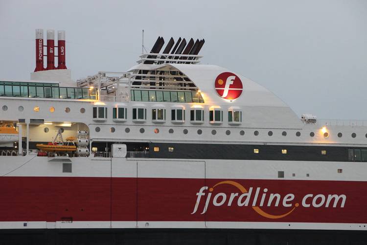 The characteristic, red painted, gas vent lines, featuring “Powered by LNG” on top of the vessel.