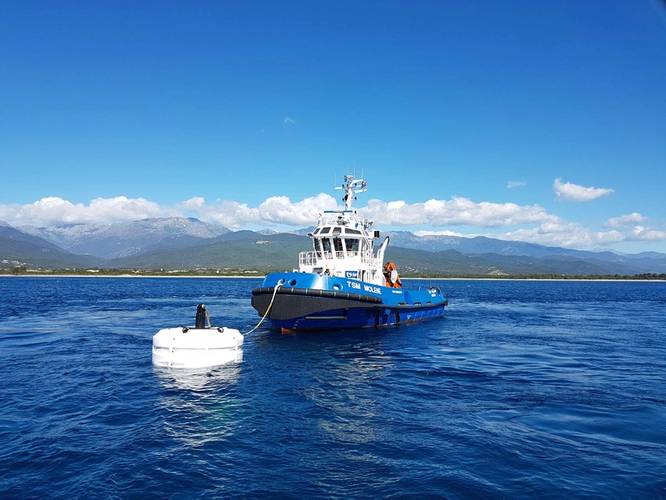 A tug is connected to the buoy for pre-tensioning.