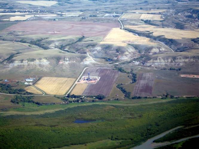 Oil-well pads dotting the landscape of typical badland topography. Thousands of new wells are drilled into the Bakken and Three Forks annually, making this one of the most productive plays in the Nation. (Source: USGS)