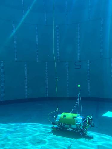 Testing the Square Robot vehicle in a test tank filled with water. The DVL1000, seen on the right, is mounted so it can work unobstructed, while maintaining a minimum distance from the floor. Image courtesy Nortek/Square Robot