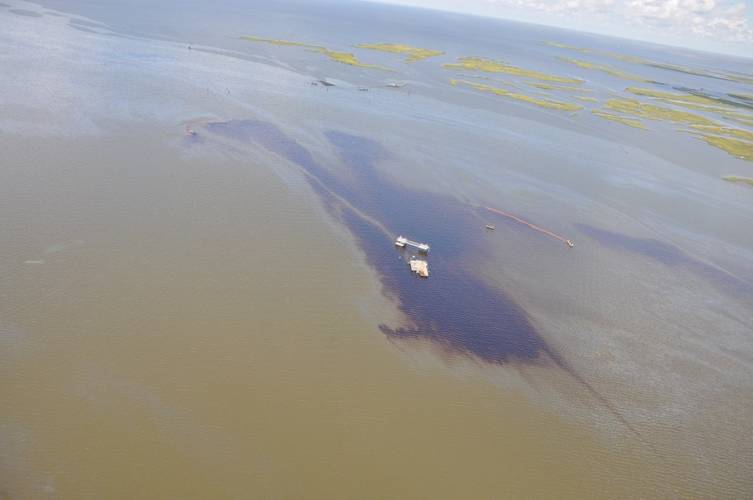 Two vessels from Environmental Safety and Health deploy boom, July 25, 2016, in response to an estimated 4,200-gallon discharge of crude oil near Lake Grande Ecaille. (U.S. Coast Guard photo courtesy of Coast Guard Air Station New Orleans)