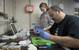 Expedition chief scientist Peter Girguis and Jennifer Delaney of Harvard University extract the viscera of a deep-sea clam collected by Alvin. A preserved sample will be sent to the Ocean Genome Legacy, which aims to archive the DNA of every marine species and make the data available to scientists.